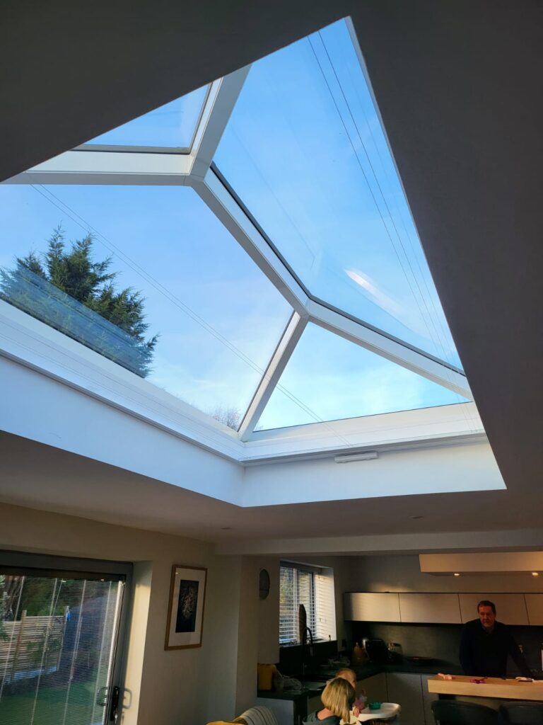 White roof lantern blinds fully open beneath overhead glazing